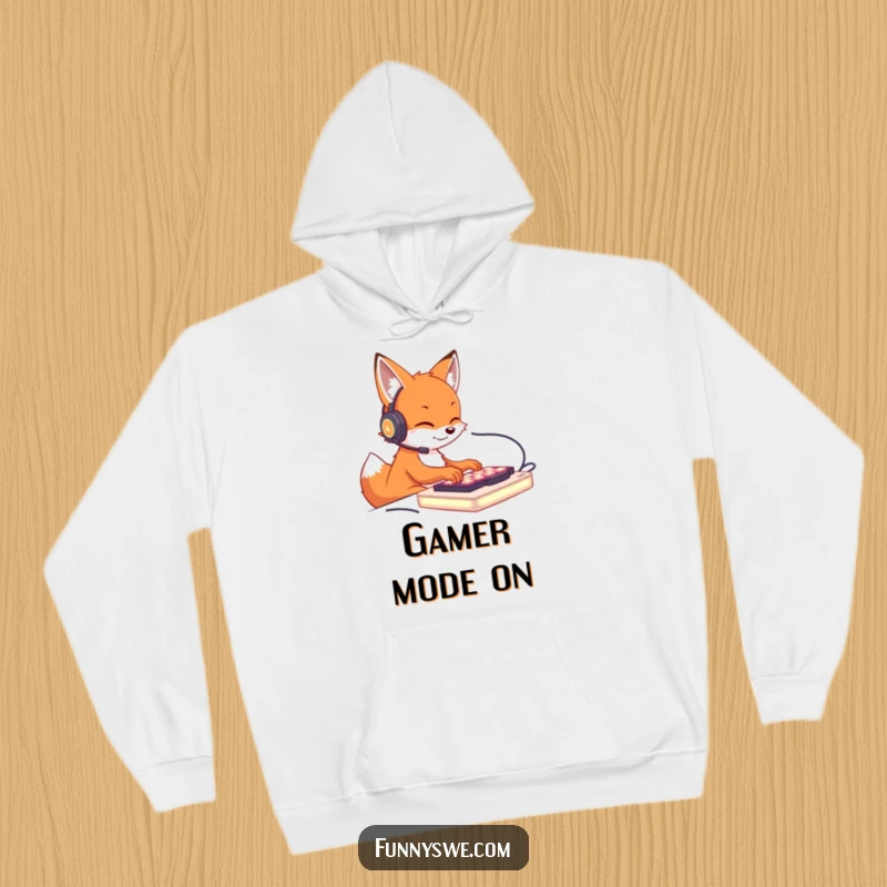 Funny hoodie design of a cute fox wearing a headset, furiously typing on an illuminated keyboard, perfect for cozy gaming.