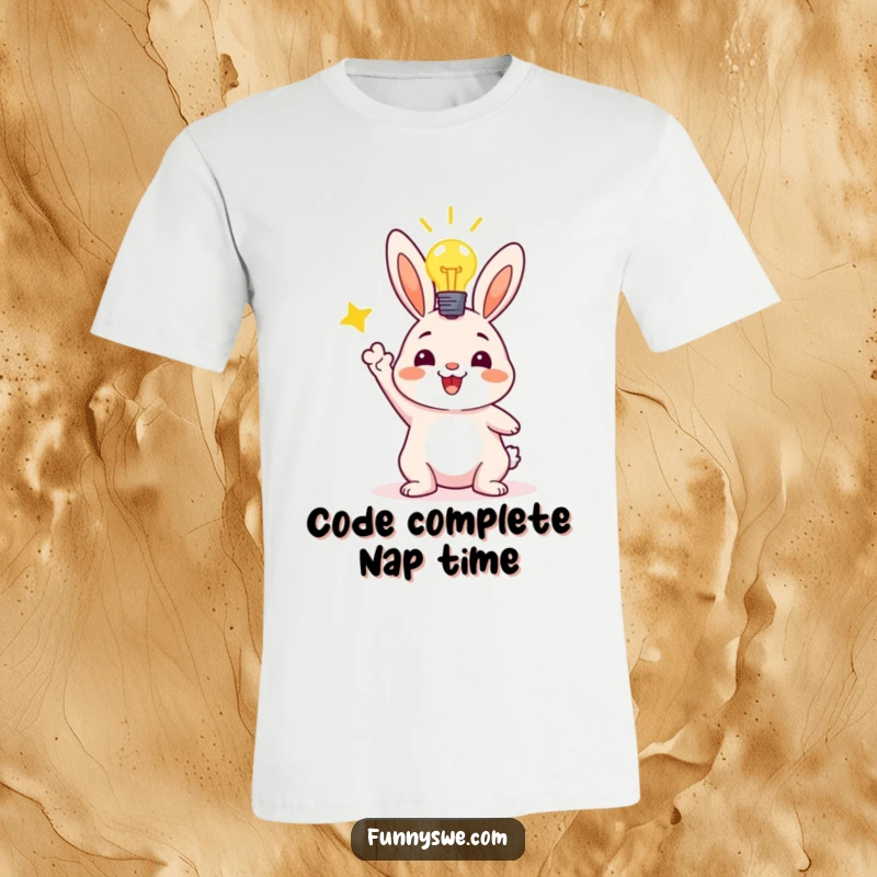 Funny t-shirt with a jubilant bunny character raising its paws in success next to a bright lightbulb, symbolizing a code deployment win.